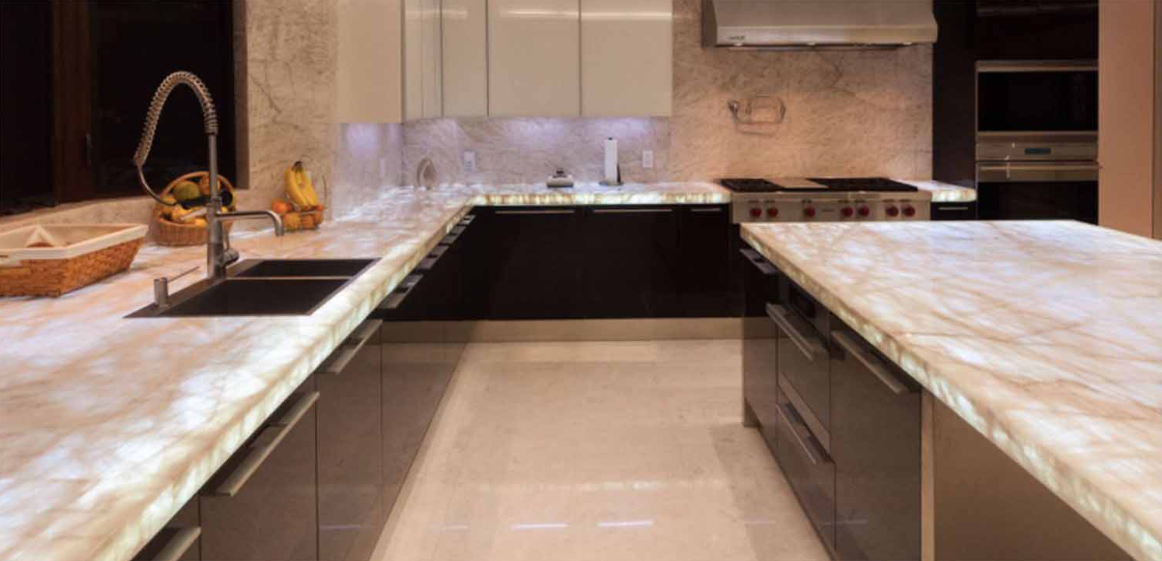 Backlit, translucent White Quartz Supreme countertops glowing in a modern kitchen.