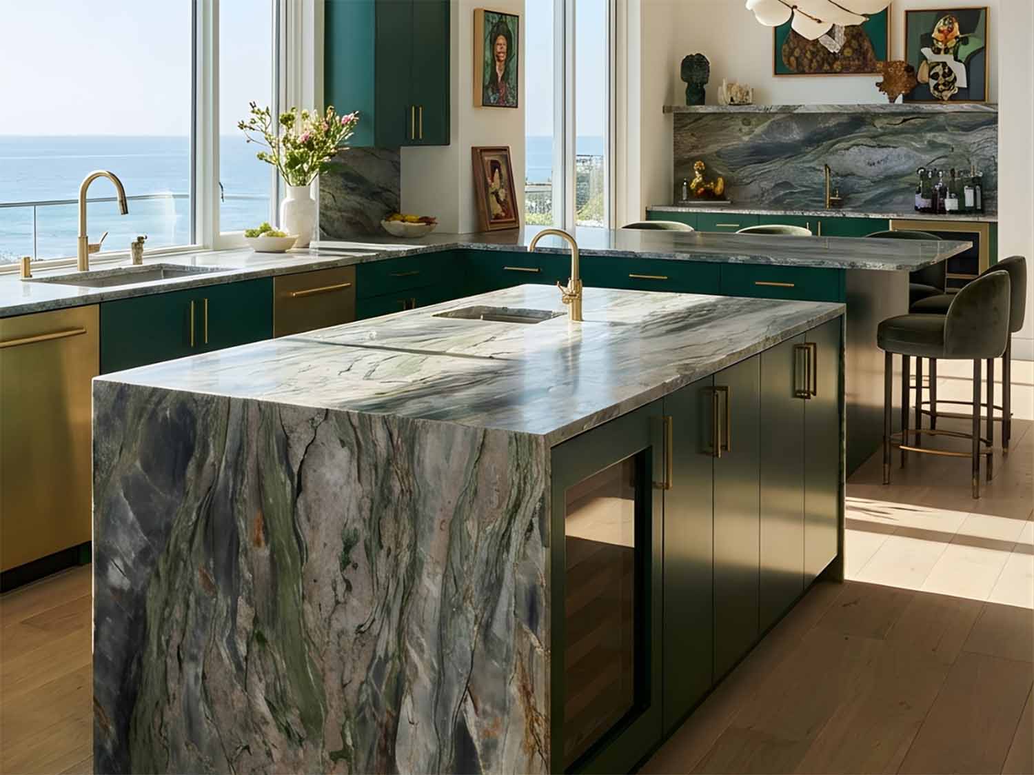 Green Sydney Quartzite waterfall island with dramatic veining in an oceanfront kitchen with emerald cabinetry.