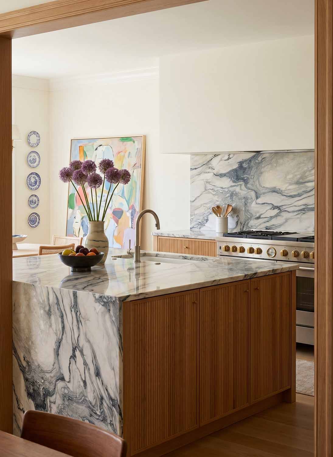 Waterfall kitchen countertop in Cipollino Azul marble.