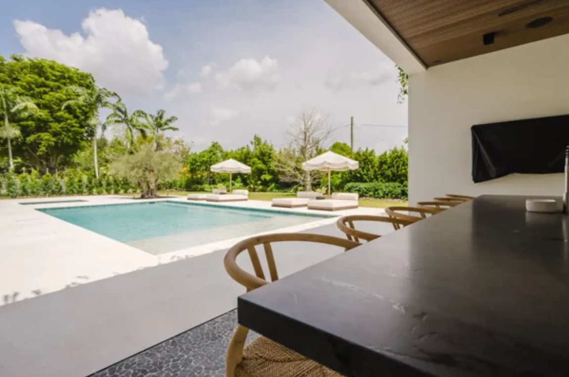 Ivory Light travertine pool deck and covered patio beside a swimming pool.