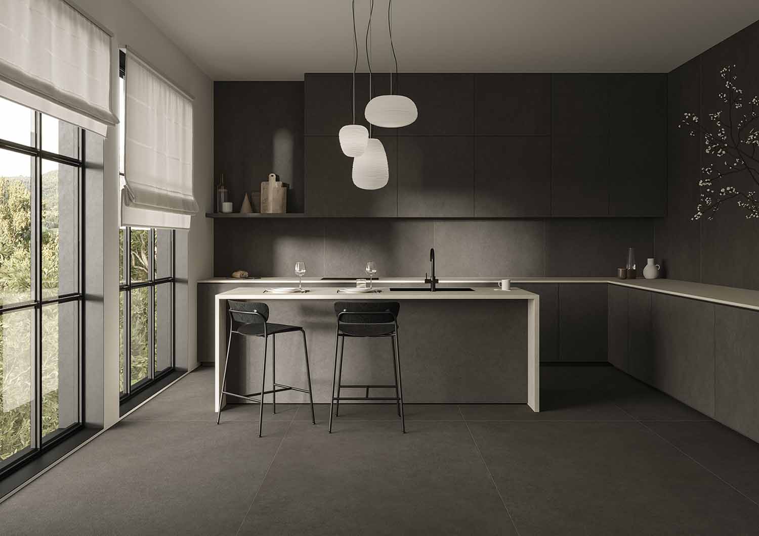 Concrete-look large format porcelain floor and wall tile in a dark, minimalist kitchen.